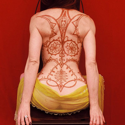 Large henna tattoo on woman's back
