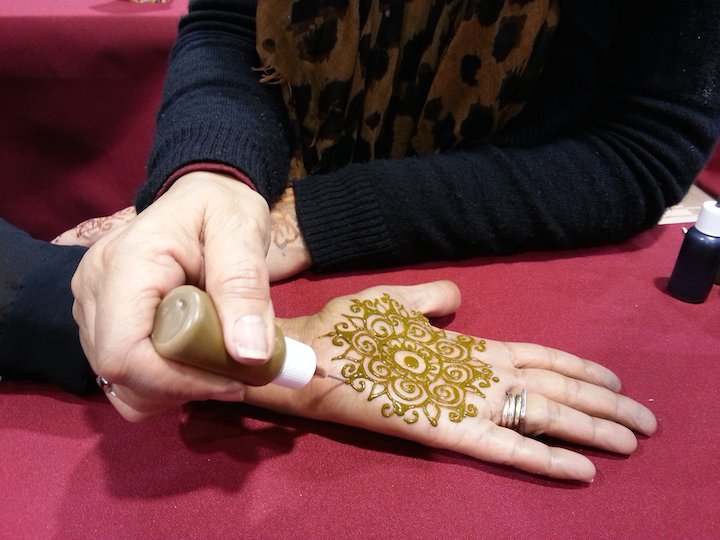Applying a henna tattoo